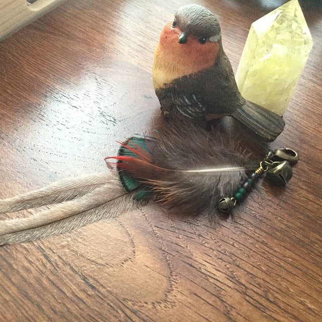 Customer image of Feather and green bead dangle charm from Hairwraps UK.